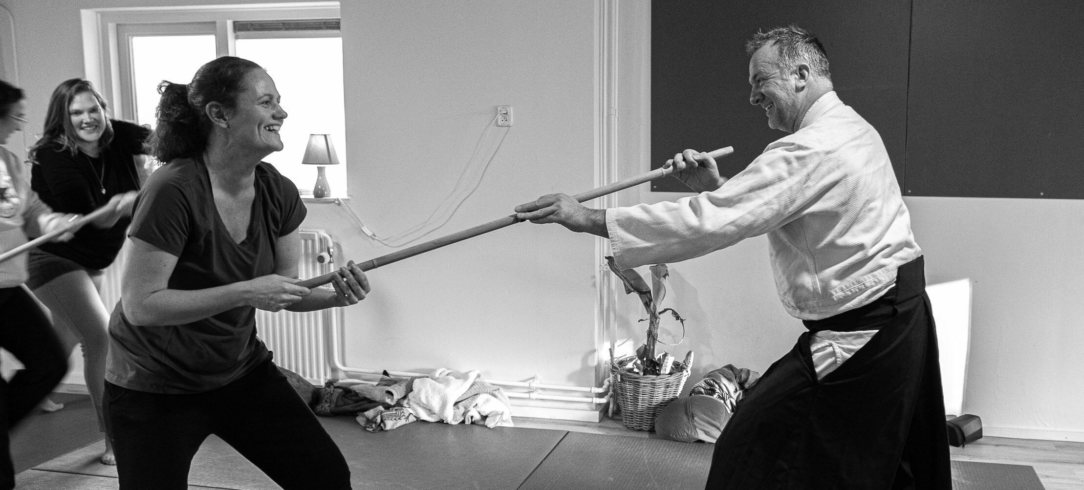Richard Jacobsen practising with a participant with the jo, a wooden staff, during a training in the dojo